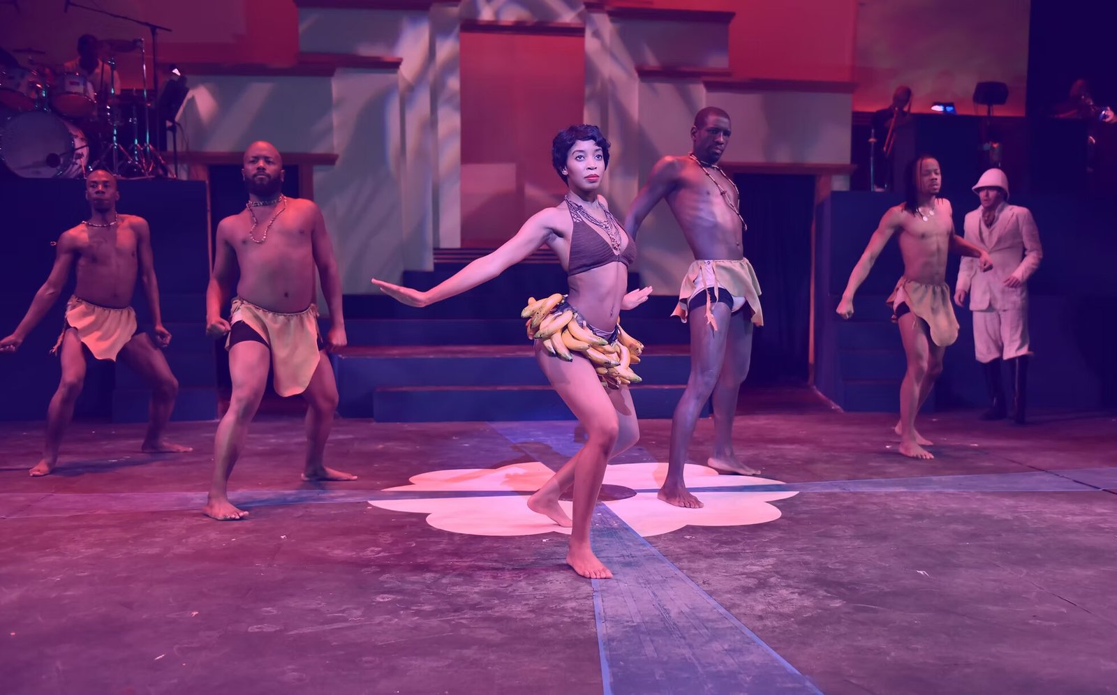 The Black Ensemble company performing on stage under theatrical light