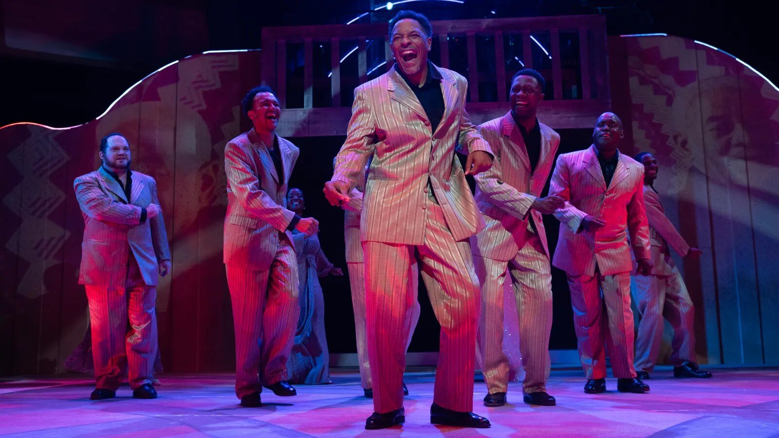 The Men of Soul company in shimmering suits, singing full-out on the Black Ensemble stage