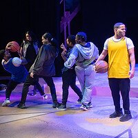 Performers in a Black Ensemble production on stage